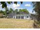 Backyard view featuring home and an enclosed pool at 949 Shadow Oaks Rd, Kissimmee, FL 34744