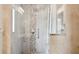 This shower is beautifully designed with glass doors and unique tile and stonework at 949 Shadow Oaks Rd, Kissimmee, FL 34744