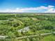 Sprawling acreage with a bright blue sky and white puffy clouds overhead at 9506 Number Two Rd, Howey In The Hills, FL 34737