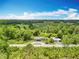 An aerial view shows the expansive property and multiple structures on it at 9506 Number Two Rd, Howey In The Hills, FL 34737