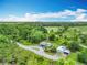 Aerial view of a charming home with outbuildings and plenty of greenspace around it at 9506 Number Two Rd, Howey In The Hills, FL 34737