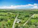 An aerial view shows the acreage and the road running in front of the property at 9506 Number Two Rd, Howey In The Hills, FL 34737
