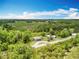 An aerial view shows the home from above along with the surrounding acreage at 9506 Number Two Rd, Howey In The Hills, FL 34737