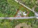 Overhead view outlines property in red, showcasing its location amid trees, structures and a road at 9506 Number Two Rd, Howey In The Hills, FL 34737