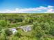 Aerial view of home with multiple outbuildings and lush natural landscaping at 9506 Number Two Rd, Howey In The Hills, FL 34737