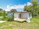 Exterior view showcasing a small deck with steps and sliding door, side of home and yard at 9506 Number Two Rd, Howey In The Hills, FL 34737