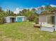 Expansive backyard featuring a patio, well-maintained lawn, and storage sheds at 9506 Number Two Rd, Howey In The Hills, FL 34737
