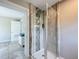 Walk-in shower featuring glass doors, tile surround, and a showerhead with a handheld at 9506 Number Two Rd, Howey In The Hills, FL 34737