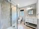 Bathroom with tile surround, glass shower door, and a gray vanity at 9506 Number Two Rd, Howey In The Hills, FL 34737