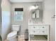 This bathroom includes a gray vanity, a window, and tile flooring at 9506 Number Two Rd, Howey In The Hills, FL 34737