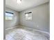 Bedroom showcasing tile floors, two windows, and neutral wall color at 9506 Number Two Rd, Howey In The Hills, FL 34737