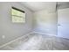 This bedroom features light gray walls, large window, and tile flooring at 9506 Number Two Rd, Howey In The Hills, FL 34737