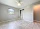 Bedroom featuring tile flooring and double-door closet with gray walls at 9506 Number Two Rd, Howey In The Hills, FL 34737