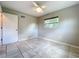 This bedroom includes tile flooring, light gray walls, and a window at 9506 Number Two Rd, Howey In The Hills, FL 34737