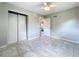This bedroom features gray walls, tile flooring, and a double-door closet at 9506 Number Two Rd, Howey In The Hills, FL 34737