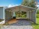 Sturdy metal carport provides covered parking space with easy access and gravel base at 9506 Number Two Rd, Howey In The Hills, FL 34737
