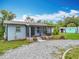 Charming one-story home featuring front porch, gravel driveway, and backyard storage at 9506 Number Two Rd, Howey In The Hills, FL 34737