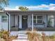 Enclosed front porch with a decorative door, steps to the house and plants in front at 9506 Number Two Rd, Howey In The Hills, FL 34737