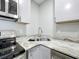 A stainless steel sink complements the stainless steel appliances and granite counters at 9506 Number Two Rd, Howey In The Hills, FL 34737