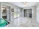 A bright living space with tile floors, a closet, and sliding glass door to the back yard at 9506 Number Two Rd, Howey In The Hills, FL 34737