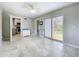 Open living area with tile flooring, ceiling fan, and view of the kitchen and backyard at 9506 Number Two Rd, Howey In The Hills, FL 34737