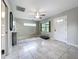 Spacious, open-concept living area featuring sleek tile floors and abundant natural light at 9506 Number Two Rd, Howey In The Hills, FL 34737