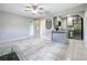 Bright, open living space flows into the kitchen, featuring sleek tile and modern finishes at 9506 Number Two Rd, Howey In The Hills, FL 34737
