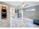Open-concept living space with modern tile floors and seamless flow to kitchen and bath at 9506 Number Two Rd, Howey In The Hills, FL 34737