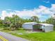 Outdoor sheds and covered area provide storage and convenience; property has plenty of space at 9506 Number Two Rd, Howey In The Hills, FL 34737