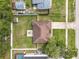 Aerial view of home featuring a large fenced backyard with patio seating and an extra storage shed at 970 Courtland Blvd, Deltona, FL 32738