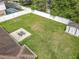 Expansive backyard with a lush lawn, patio set, shed, and privacy fence, perfect for outdoor activities at 970 Courtland Blvd, Deltona, FL 32738