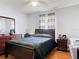 This cozy bedroom features a ceiling fan, wood floors, and a large window, creating a comfortable and inviting space at 970 Courtland Blvd, Deltona, FL 32738