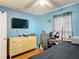 Bedroom with blue walls, wood floors, and closet space at 970 Courtland Blvd, Deltona, FL 32738