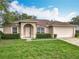 Charming single-story home with a manicured lawn and attached two-car garage at 970 Courtland Blvd, Deltona, FL 32738
