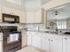 Bright kitchen with white cabinetry, granite countertops, and stainless steel appliances at 970 Courtland Blvd, Deltona, FL 32738