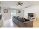 Comfortable living room with tiled floors, modern ceiling fan, and sliding glass doors at 970 Courtland Blvd, Deltona, FL 32738