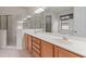 Modern bathroom with double sink vanity, tiled floors, and a glass-enclosed shower at 9852 Caroline Park Dr, Orlando, FL 32832