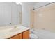 Bright bathroom featuring a vanity with a marble countertop and a bathtub with tile surround at 9852 Caroline Park Dr, Orlando, FL 32832