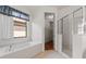 Clean bathroom featuring a soaking tub, glass shower, and tiled floor at 9852 Caroline Park Dr, Orlando, FL 32832