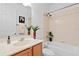 Clean bathroom with neutral tones, a vanity, and a shower-tub combo at 9852 Caroline Park Dr, Orlando, FL 32832