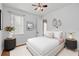 Stylishly decorated bedroom with neutral walls, a ceiling fan, and modern furnishings at 9852 Caroline Park Dr, Orlando, FL 32832