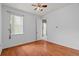 Empty bedroom features laminate floors, natural light from window, and a ceiling fan at 9852 Caroline Park Dr, Orlando, FL 32832