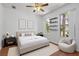 Bedroom with hardwood floors, natural light, fan, and view to outside at 9852 Caroline Park Dr, Orlando, FL 32832