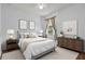 Cozy bedroom with soft lighting, neutral decor, and wood furnishings at 9852 Caroline Park Dr, Orlando, FL 32832