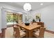 A dining room with wood table, rug, and sliding glass doors with a view of the pool at 9852 Caroline Park Dr, Orlando, FL 32832