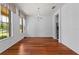 Spacious dining room featuring hardwood floors, natural light, and elegant chandelier at 9852 Caroline Park Dr, Orlando, FL 32832