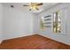 Bright empty room with hardwood floors, natural light, and a ceiling fan at 9852 Caroline Park Dr, Orlando, FL 32832