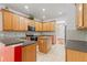 Bright eat-in kitchen with wood cabinets, stainless steel appliances, and an island at 9852 Caroline Park Dr, Orlando, FL 32832