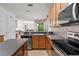 Spacious kitchen with granite counters, stainless steel appliances, and a seamless view to the living room at 9852 Caroline Park Dr, Orlando, FL 32832