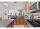 Spacious kitchen with granite counters, stainless steel appliances, and a seamless view to the living room at 9852 Caroline Park Dr, Orlando, FL 32832